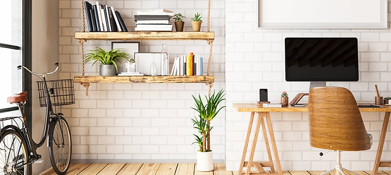 photo of a cozy modern workspace with plants, wooden furniture, a bicycle and white subway tile walls